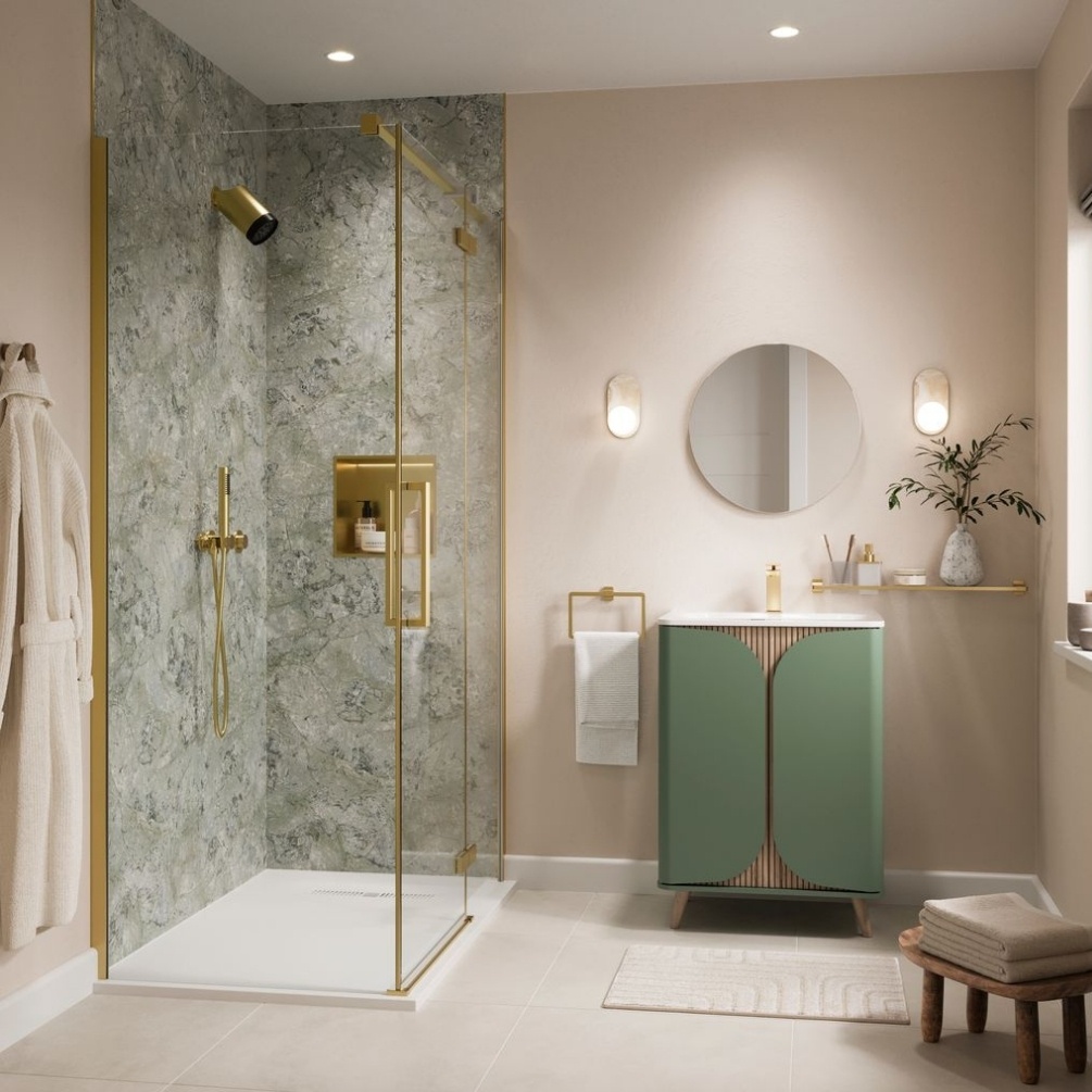 Lifestyle image of the Showerwall Laminate Classico Verde 2440mm x 879mm Proclick Hydrocore Wall Panel - SW92 in a walk-in shower enclosure with brushed brass detailing, green wall-hung vanity unit with basin, and round mirror